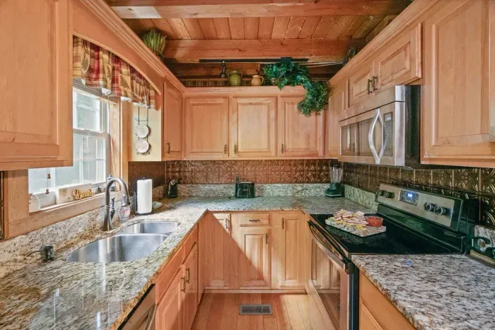 Cozy rustic kitchen with granite counters and stainless appliances