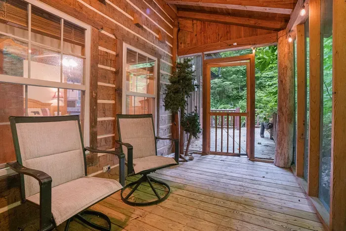 Cozy covered porch with forest views and relaxing cabin seating
