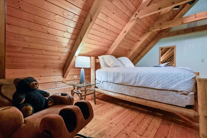 Cozy loft bedroom with rustic wood beams and charming cabin style