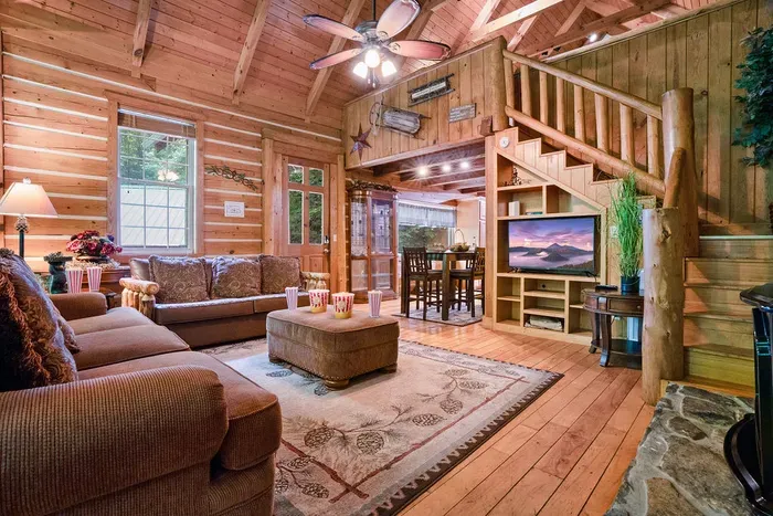 Cozy log cabin living room with vaulted ceilings and rustic charm