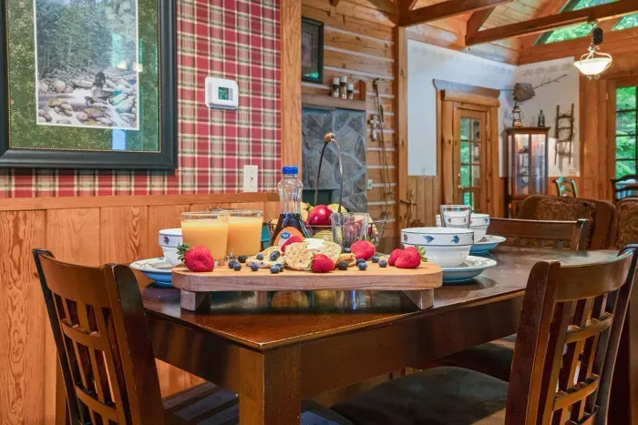 Cozy cabin dining area with rustic charm and a guest-ready breakfast spread
