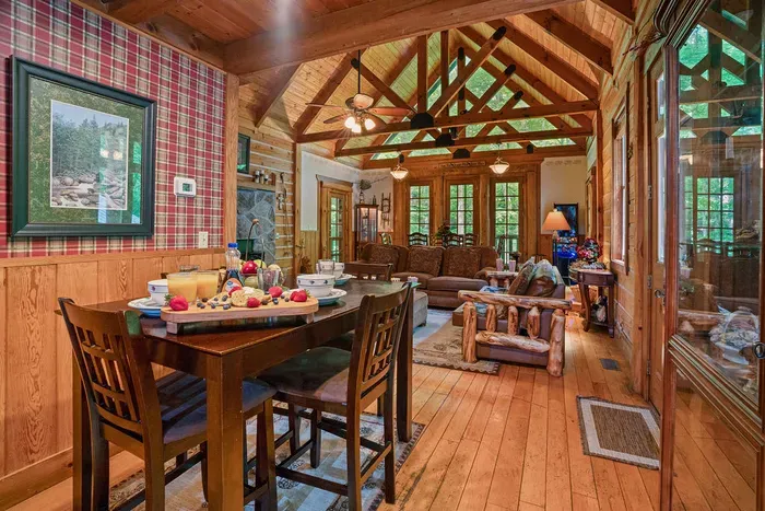 Rustic great room with vaulted wood ceilings and serene forest views