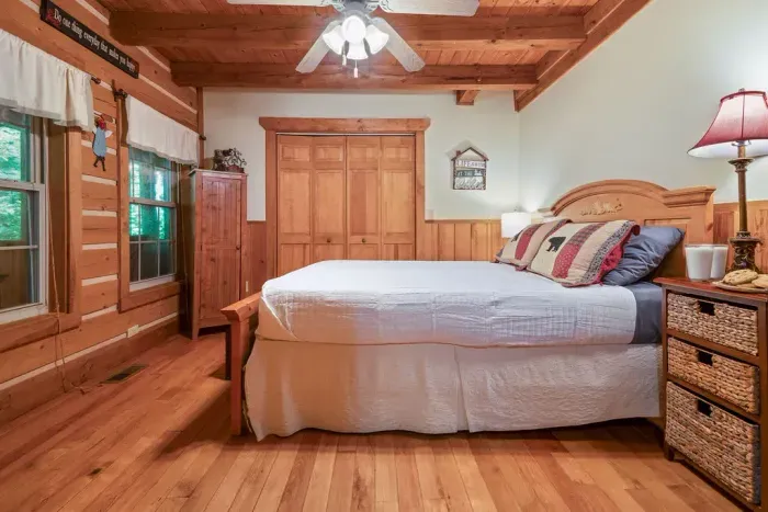 Cozy rustic bedroom with warm wood finishes and inviting lodge charm