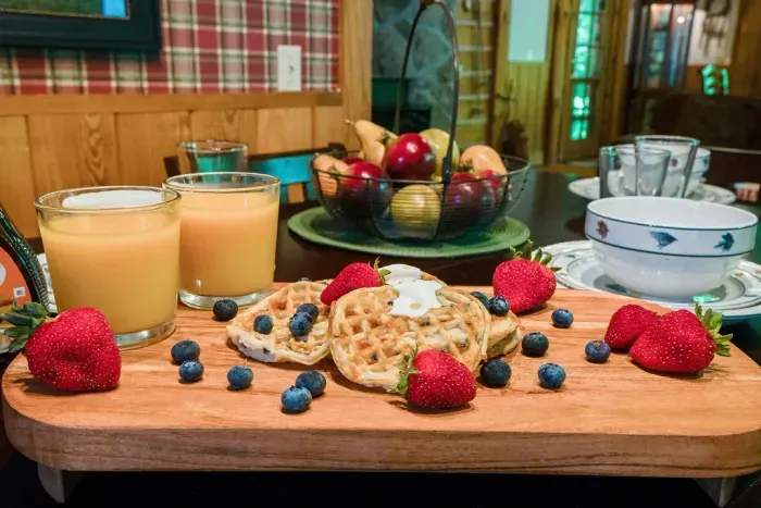 Cozy cabin breakfast spread with fresh waffles, berries, and juice