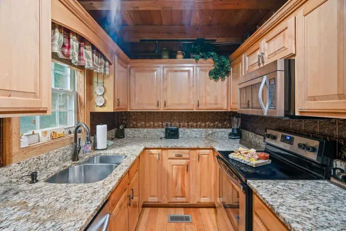 Cozy wood-accented kitchen with granite counters and stainless appliances