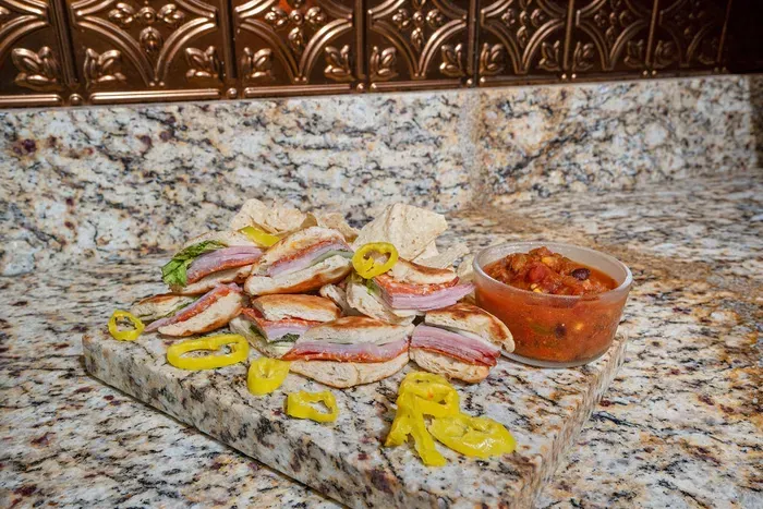 Stylish kitchen presentation with savory mini sandwiches and granite finishes