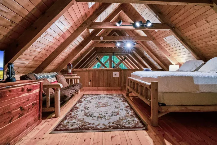 Cozy rustic loft with log bed, vaulted ceilings, and inviting cabin charm