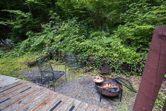 Cozy woodland fire pit seating just off the deck