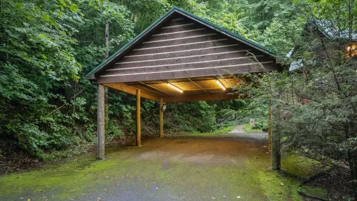 Covered parking in a peaceful wooded setting with private cabin charm