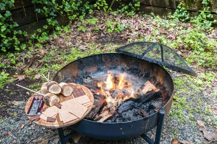 Cozy outdoor fire pit with s’mores setup for memorable evenings