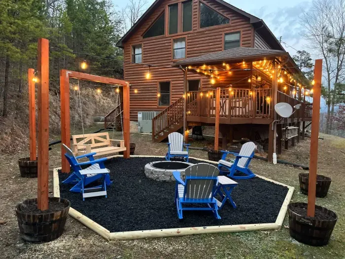 Large outdoor firepit with oak barrels, cafe lighting, Adirondack chairs, swinging seat and views 