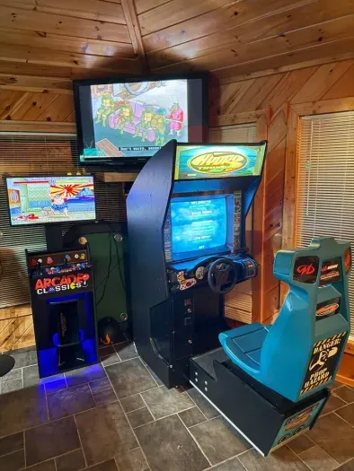 Arcades and streaming TV in the downstairs game room with billiards, poker table and bar seating 