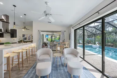 Bright and open living space with modern kitchen and seamless access to the pool — perfect for a relaxing vacation.