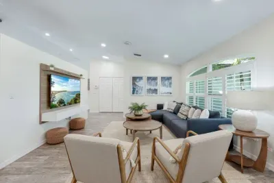 Bright, welcoming living room designed for comfort and connection-featuring a comfy sofa, plush accent chairs and a smart TV ready for movie nights.