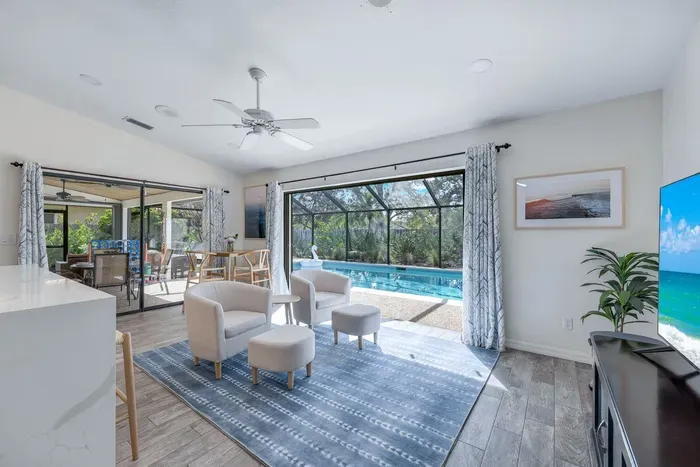Inviting family room with a breakfast nook and pocket sliding doors to pool area, comfy chairs, and a TV-great for unwinding.