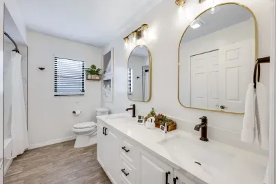 Modern guest bathroom with a spacious double-sink vanity and a shower/tub combo—ideal for comfort and convenience during your stay.