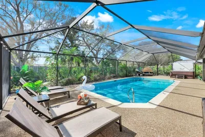 Sun-drenched poolside retreat featuring plush chaise lounges, a soothing hot tub, and a dreamy daybed made for slow mornings and sunset unwinding.