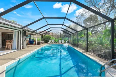 Your own private getaway includes a pool with a screened enclosure, perfect for relaxing swims in a bug-free, sun-filled space.