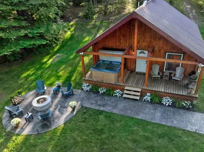A bird’s-eye view of your home in the woods, with the new fire-pit patio just outside the cabin.