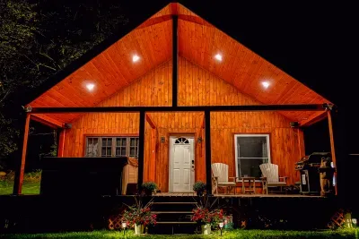 End your day right here—soft lights, quiet woods, and a front porch that invites you to slow down and stay awhile.