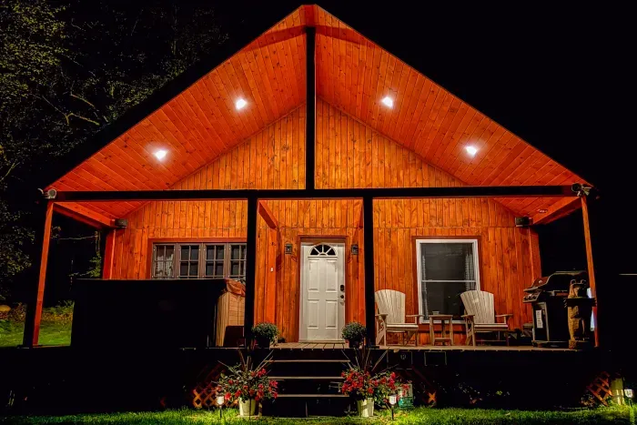 End your day right here—soft lights, quiet woods, and a front porch that invites you to slow down and stay awhile.