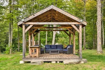 Settle into your own outdoor lounge—plush seating, peaceful pond views, and the perfect place to sip, snack, and truly unwind.