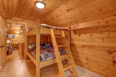 Comfortable upstairs bedroom with full-sized bunk beds—ideal for families with children or groups.