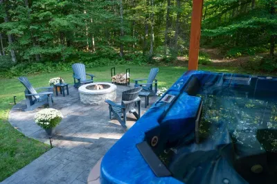 Two ways to unwind, just steps apart—soak in the hot tub or settle in around the fire.