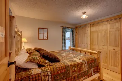 Master bedroom with queen bed embodies simplicity and comfort.
