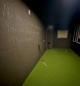 This is a secret room hidden in the basement! Two hole Golf Putter Room with dart board.