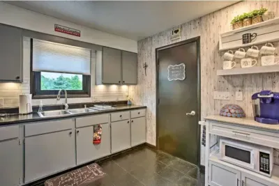 Holy Cow Side Kitchen Area - Door opens to recreation garage area, additional dining, seating and flat screen smart TV's.