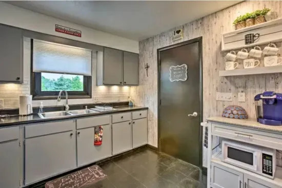 Holy Cow Side Kitchen Area - Door opens to recreation garage area, additional dining, seating and flat screen smart TV's.