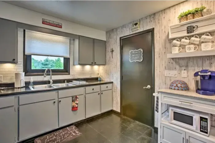 Holy Cow Side Kitchen Area - Door opens to recreation garage area, additional dining, seating and flat screen smart TV's. 