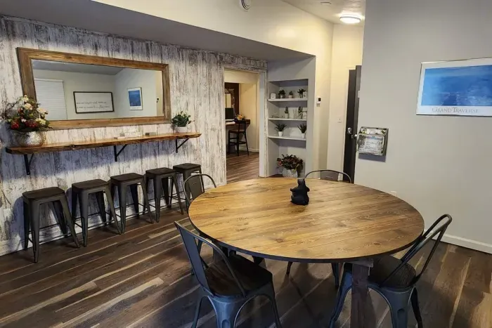 A Large Card & Board Game Room with deck access and a live edge bar that doubles as a long vanity | Ample space when everyone needs to get ready together.