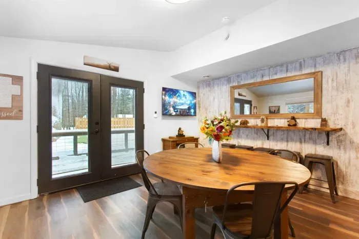 A Large Card & Board Game Room with deck access and a live edge bar that doubles as a long vanity | Ample space when everyone needs to get ready together.
