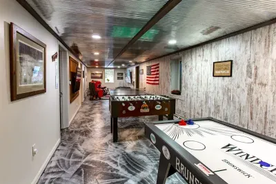 Lower Level game room - Air Hockey, Foosball, Ping Pong, plus Flat Screens for Movies, Gaming and Sports Fans.