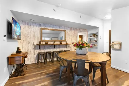 A Large Card & Board Game Room with deck access and a live edge bar that doubles as a long vanity | Ample space when everyone needs to get ready together.