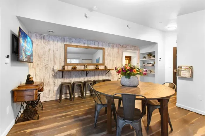 A Large Card & Board Game Room with deck access and a live edge bar that doubles as a long vanity | Ample space when everyone needs to get ready together.