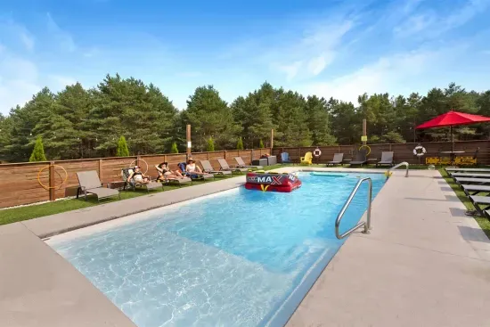 70's Lodge Pool House | Lounge Area | Changing Room | Work-out Equipment | Arcade Games | Indoor- Outdoor Smart TV's | Disco Lights | Radiant Heat | Dry Bar & Bar Stools | Refrigerator | Corn