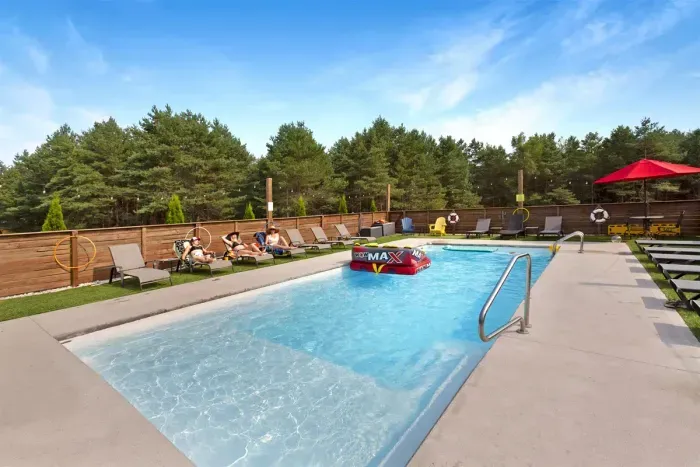 70's Lodge Pool House | Lounge Area | Changing Room | Work-out Equipment | Arcade Games | Indoor- Outdoor Smart TV's | Disco Lights | Radiant Heat | Dry Bar & Bar Stools | Refrigerator | Corn