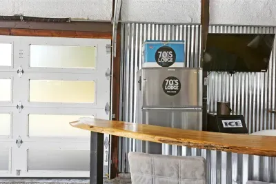 70's Lodge Pool House | Lounge Area | Changing Room | Work-out Equipment | Arcade Games | Indoor- Outdoor Smart TV's | Disco Lights | Radiant Heat | Dry Bar | ICE Maker | Refrigerator | Corn