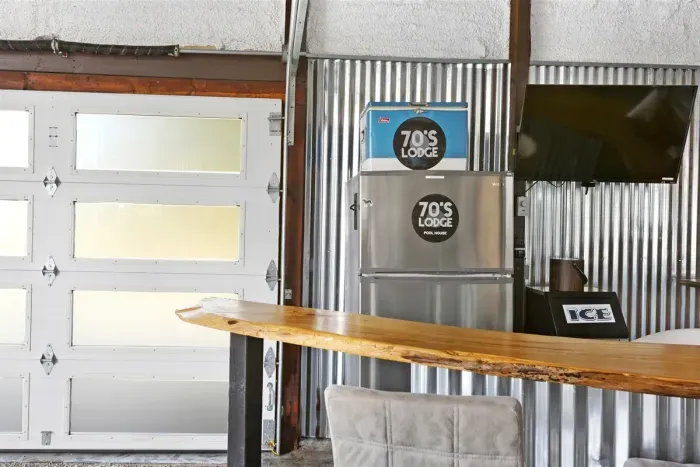 70's Lodge Pool House | Lounge Area | Changing Room | Work-out Equipment | Arcade Games | Indoor- Outdoor Smart TV's | Disco Lights | Radiant Heat | Dry Bar | ICE Maker | Refrigerator | Corn