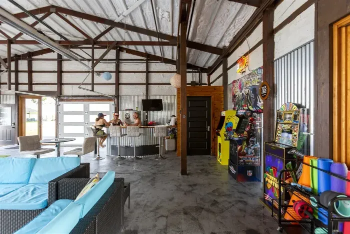 70's Lodge Pool House | Lounge Area | Changing Room | Work-out Equipment | Arcade Games | Indoor- Outdoor Smart TV's | Disco Lights | Radiant Heat | Dry Bar & Bar Stools | Refrigerator | Corn