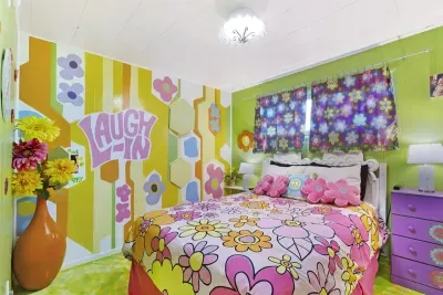 "Laugh In" Queen Bedroom | Main Floor Bedroom Wing, across hall from Blue Green Flower Pops Full Bathroom, between Partridge Family Bedroom Suite and Charlie's Angels Trundle Bedroom