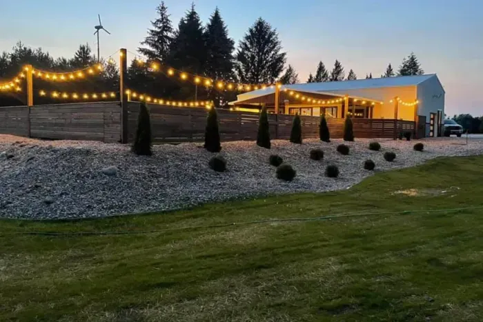 Outdoor Private Pool & House Night lit with string light garland.