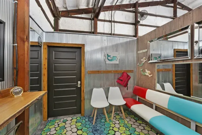 70's Lodge Pool House | Lounge Area | Changing Room | Work-out Equipment | Arcade Games | Indoor- Outdoor Smart TV's | Disco Lights | Radiant Heat | Dry Bar & Bar Stools | Refrigerator | Corn