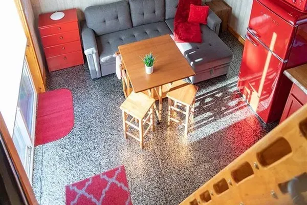 Loft view of living dining area and Full-size fold out couch.