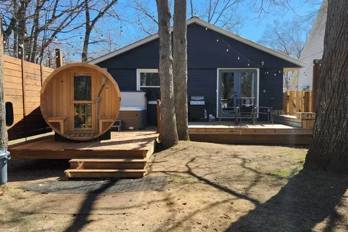 Traverse City Bungalow Spa Retreat | Adventure North Vacation Rentals | Privacy enclosed backyard, surrounded with string lighting | Pet Friendly 