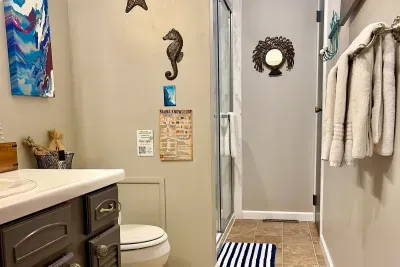 Traverse City Bungalow Spa Retreat | Full Bath Tub Shower Combo | Adventure North Vacation Rentals | Get ready for the day in this bathroom!