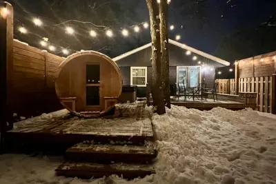 Traverse City Bungalow Spa Getaway | Adventure North Vacation Rentals | Outdoor Hot Tub | Barrel Sauna | Cold Plunge Barrel | String Lit Private Fenced Back Yard | Fire-pit